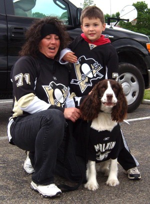 photo of penguins fans with dog