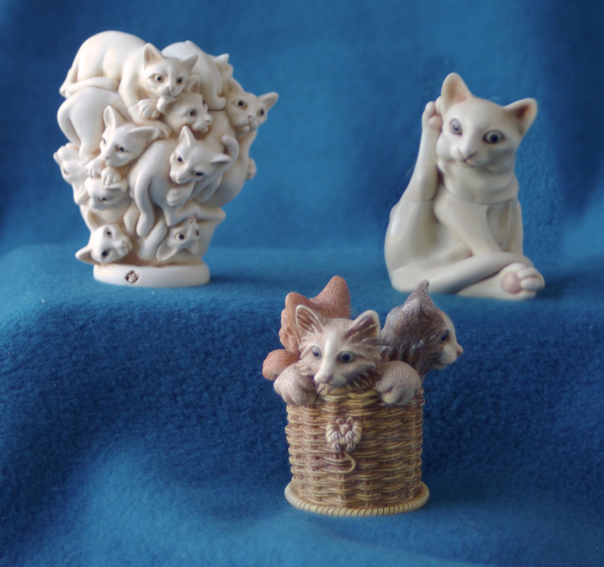 three cat figurines
