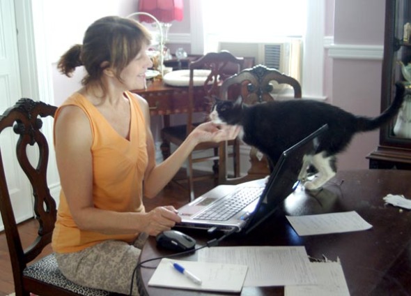 woman on computer with cat